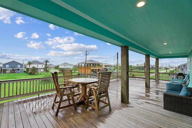 886 Sandollar, Crystal Beach, TX 77650 - wooden deck with outdoor dining space, a yard, and a residential view