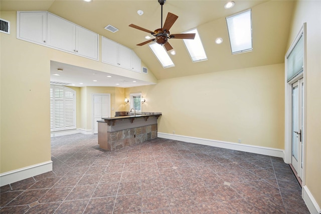 2 Wexford Ct, Piney Point Village, TX 77024 - unfurnished living room featuring a skylight, ceiling fan, baseboards, high vaulted ceiling, and recessed lighting