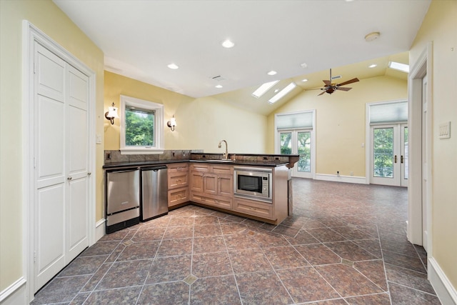 2 Wexford Ct, Piney Point Village, TX 77024 - kitchen featuring appliances with stainless steel finishes, dark countertops, ceiling fan, a sink, and a peninsula