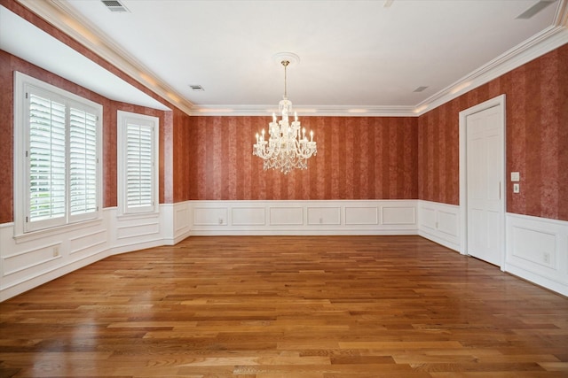 2 Wexford Ct, Piney Point Village, TX 77024 - empty room with a chandelier, a wainscoted wall, wood finished floors, and ornamental molding