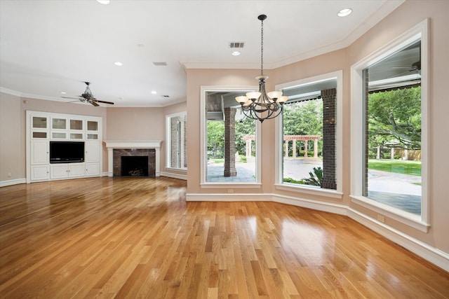2 Wexford Ct, Piney Point Village, TX 77024 - unfurnished living room featuring plenty of natural light, a chandelier, ornamental molding, baseboards, and a high end fireplace