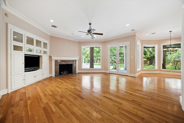 2 Wexford Ct, Piney Point Village, TX 77024 - unfurnished living room with light wood-style floors, a chandelier, a high end fireplace, a ceiling fan, and crown molding