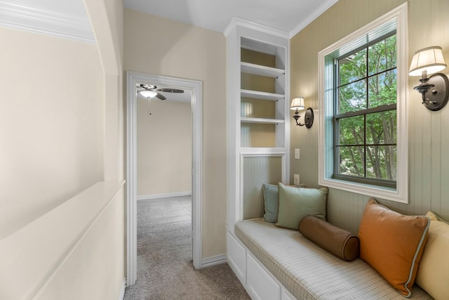 interior space with crown molding, baseboards, and carpet