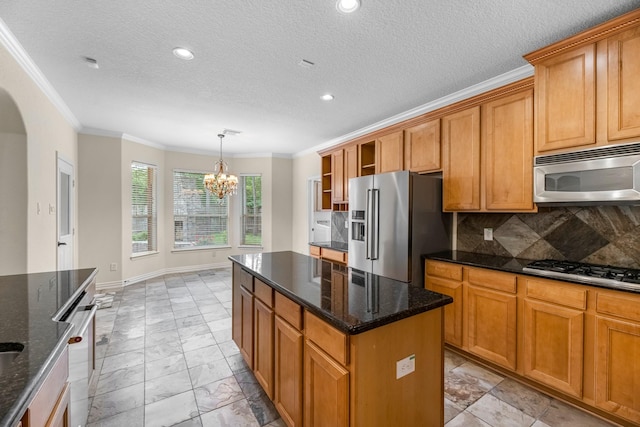 kitchen with appliances with stainless steel finishes, arched walkways, marble finish floor, a notable chandelier, and ornamental molding