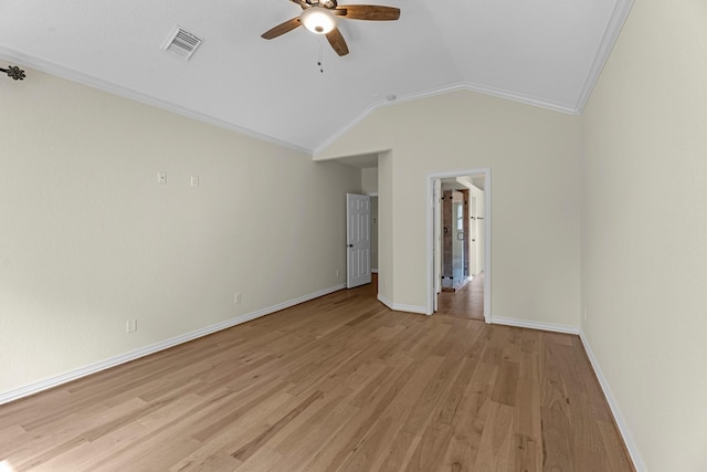 unfurnished bedroom with visible vents, crown molding, baseboards, lofted ceiling, and light wood-style flooring