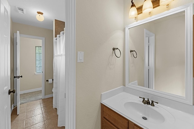 full bath with vanity, baseboards, tile patterned floors, and visible vents