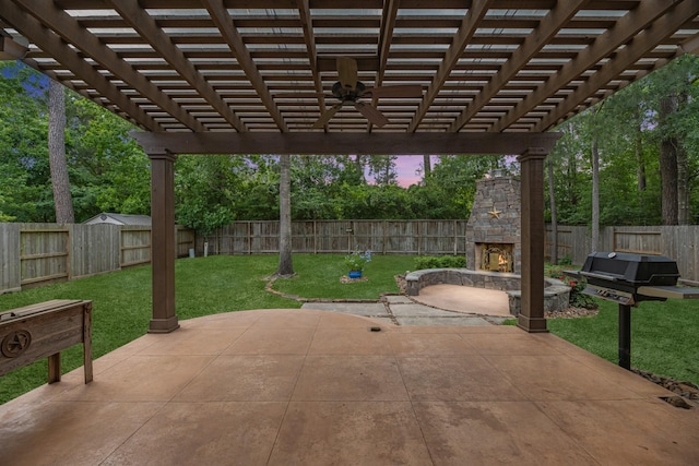 view of patio with an outdoor stone fireplace, ceiling fan, a fenced backyard, and a pergola