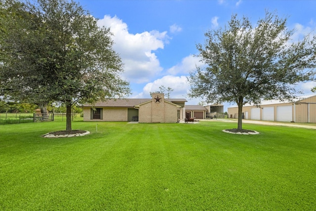 back of house with a garage, fence, driveway, and a yard