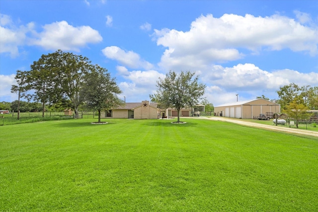 view of yard featuring fence and driveway