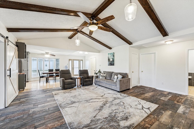 living area with a textured ceiling, hardwood / wood-style flooring, a barn door, a ceiling fan, and vaulted ceiling with beams