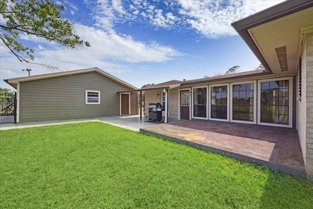 back of house with a yard and a patio area