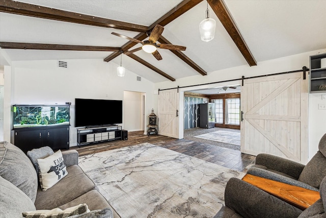 living room featuring a barn door, ceiling fan, visible vents, wood finished floors, and vaulted ceiling with beams