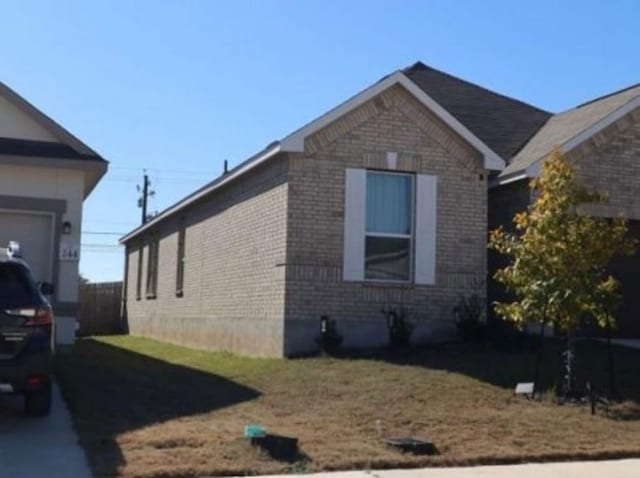 view of side of home featuring brick siding