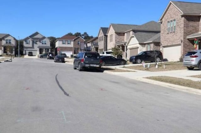 view of street with curbs, sidewalks, and a residential view