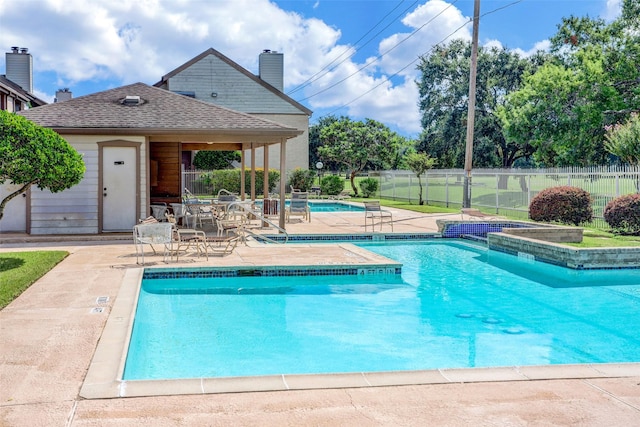 pool with fence and a patio area