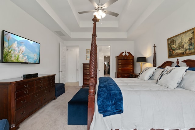 1025 Mission River Dr, Conroe, TX 77304 - bedroom featuring connected bathroom, ceiling fan, a tray ceiling, visible vents, and light carpet
