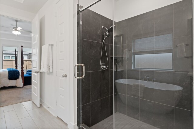 1025 Mission River Dr, Conroe, TX 77304 - ensuite bathroom featuring tile patterned floors, a shower stall, ceiling fan, and connected bathroom