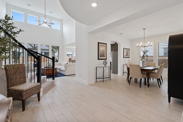 1025 Mission River Dr, Conroe, TX 77304 - entryway featuring stairway, arched walkways, light wood finished floors, and plenty of natural light