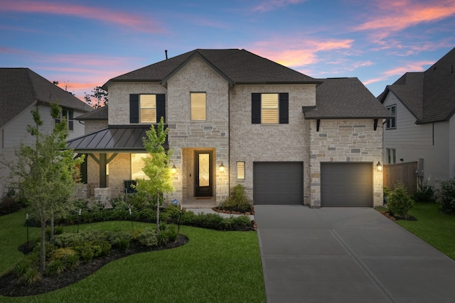 1025 Mission River Dr, Conroe, TX 77304 - french provincial home featuring a lawn, driveway, stone siding, roof with shingles, and an attached garage