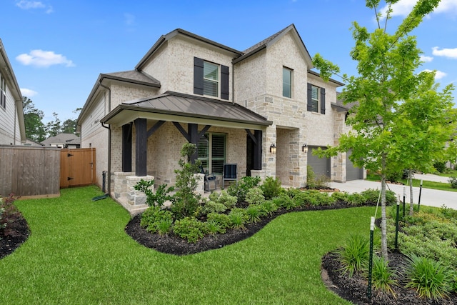 1025 Mission River Dr, Conroe, TX 77304 - view of front of home featuring covered porch, a standing seam roof, fence, driveway, and a front yard