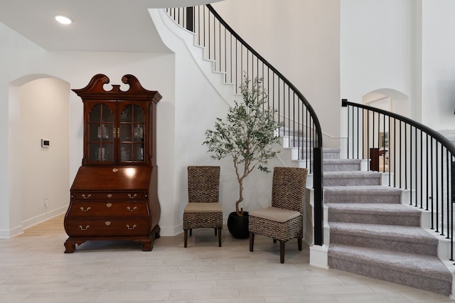 1025 Mission River Dr, Conroe, TX 77304 - staircase featuring baseboards, recessed lighting, arched walkways, and wood finished floors