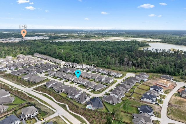 1025 Mission River Dr, Conroe, TX 77304 - drone / aerial view featuring a residential view, a water view, and a wooded view