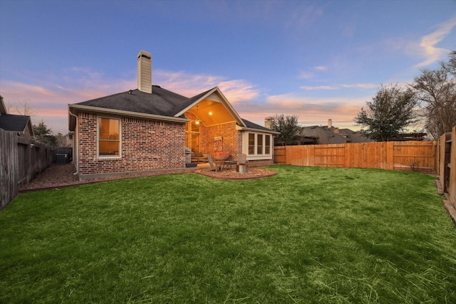 8143 Black Percher St, Conroe, TX 77385 - rear view of house with a chimney, brick siding, cooling unit, and a shingled roof