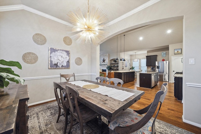 8143 Black Percher St, Conroe, TX 77385 - dining area with wood finished floors, a chandelier, arched walkways, baseboards, and lofted ceiling