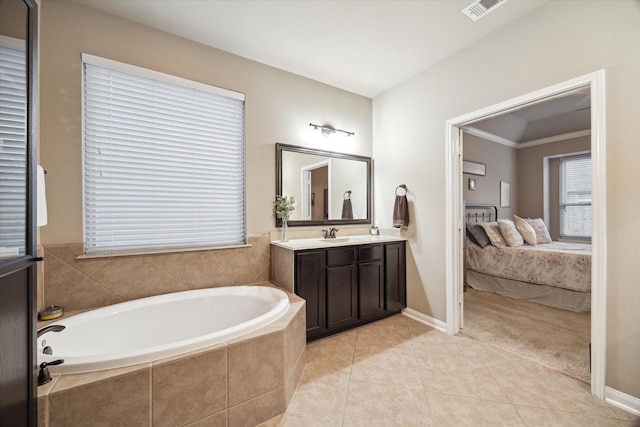 8143 Black Percher St, Conroe, TX 77385 - ensuite bathroom featuring a garden tub, vanity, tile patterned flooring, and baseboards