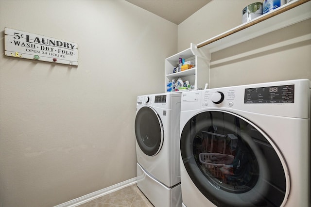8143 Black Percher St, Conroe, TX 77385 - washroom featuring washing machine and clothes dryer, baseboards, and light tile patterned floors