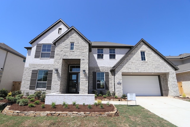 view of front of home with concrete driveway, stone siding, and a garage