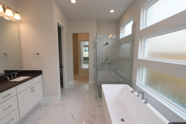 full bathroom featuring recessed lighting, a marble finish shower, a freestanding bath, and baseboards