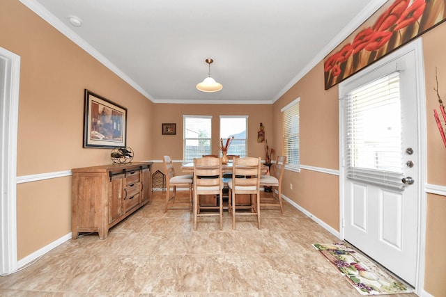 dining space with baseboards and ornamental molding
