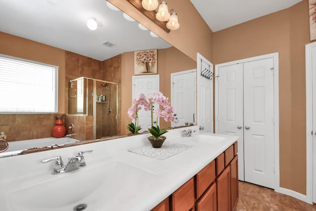 full bath featuring a sink, a garden tub, a shower stall, and double vanity