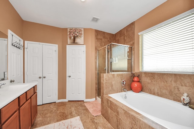 bathroom with visible vents, a bath, a stall shower, and vanity