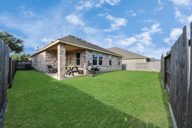 back of property featuring central AC, a patio, a fenced backyard, brick siding, and a lawn