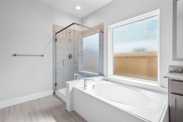 3015 Knotty Forest Dr, Spring, TX 77373 - full bath featuring a garden tub, a stall shower, baseboards, vanity, and recessed lighting