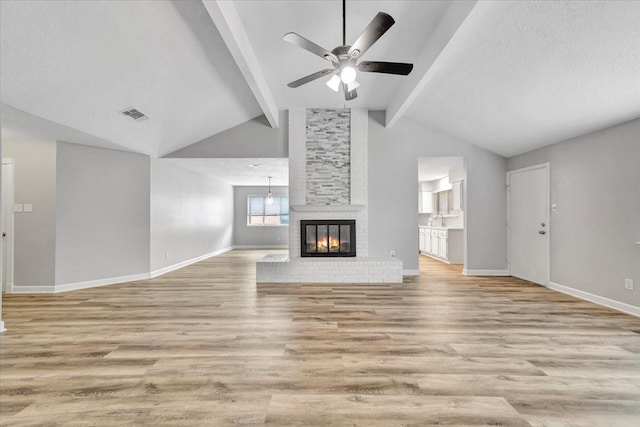 unfurnished living room featuring a ceiling fan, light wood-style flooring, and baseboards