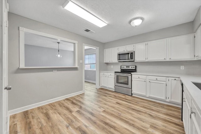 kitchen featuring white cabinetry, visible vents, and appliances with stainless steel finishes