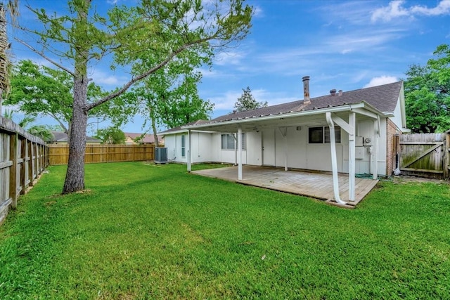 back of house with a wooden deck, a fenced backyard, central AC unit, and a lawn