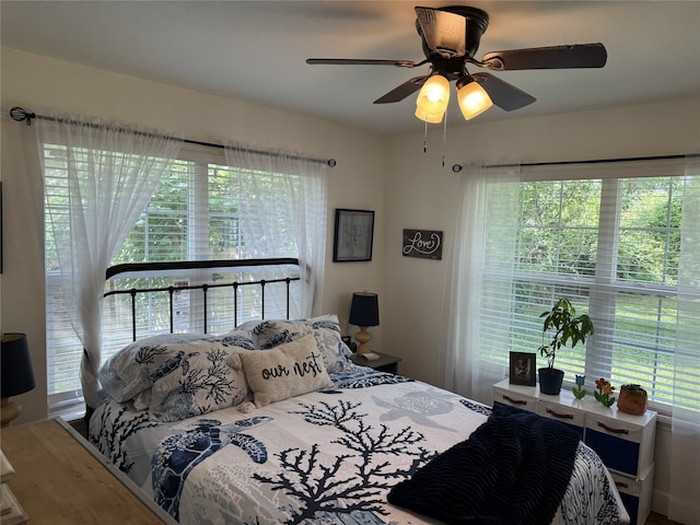 211 Southern Oaks Dr, Lake Jackson, TX 77566 - bedroom with multiple windows, ceiling fan, and wood finished floors
