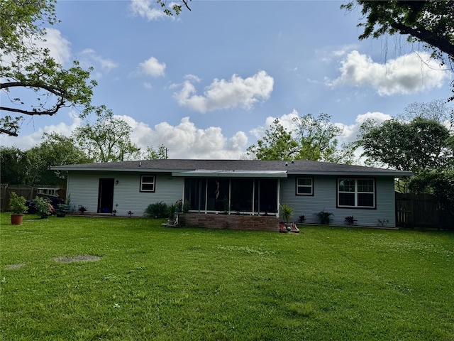 211 Southern Oaks Dr, Lake Jackson, TX 77566 - rear view of property featuring fence, a yard, and a sunroom