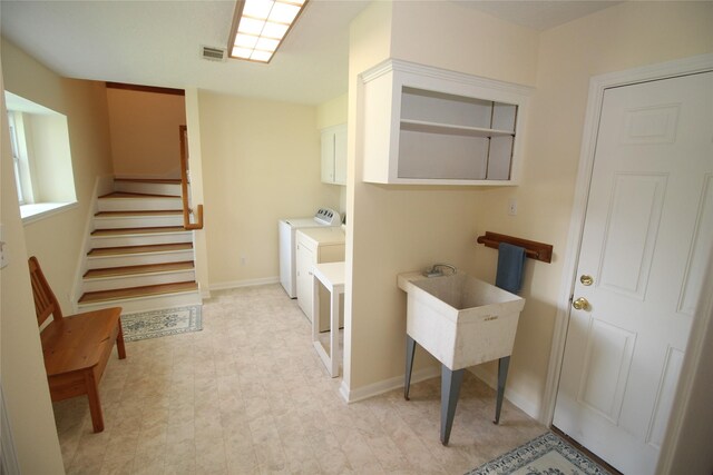 16514 Laurelfield Dr, Houston, TX 77059 - laundry room with cabinet space, washer and clothes dryer, light floors, and baseboards