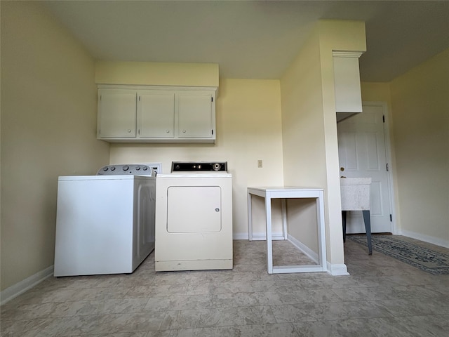 16514 Laurelfield Dr, Houston, TX 77059 - washroom featuring washer and clothes dryer, cabinet space, and baseboards