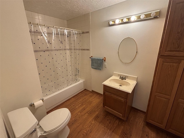 16514 Laurelfield Dr, Houston, TX 77059 - bathroom with a textured ceiling, toilet, wood finished floors, vanity, and shower / bath combo with shower curtain
