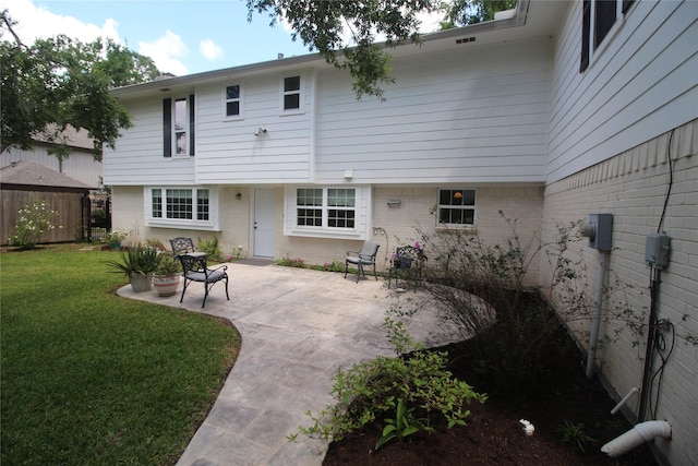 16514 Laurelfield Dr, Houston, TX 77059 - back of property with a patio, brick siding, and a yard