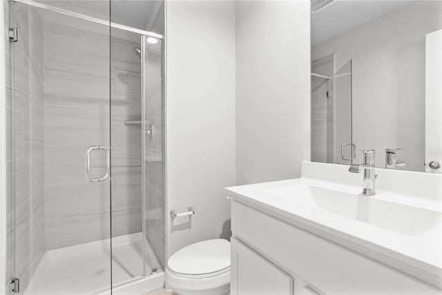 full bathroom with a stall shower, toilet, and vanity