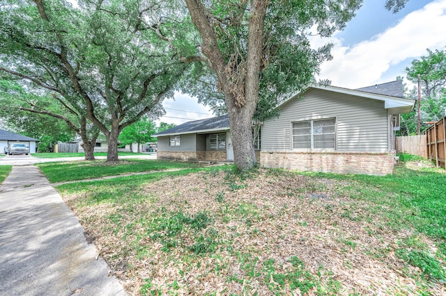 ranch-style home with brick siding and fence