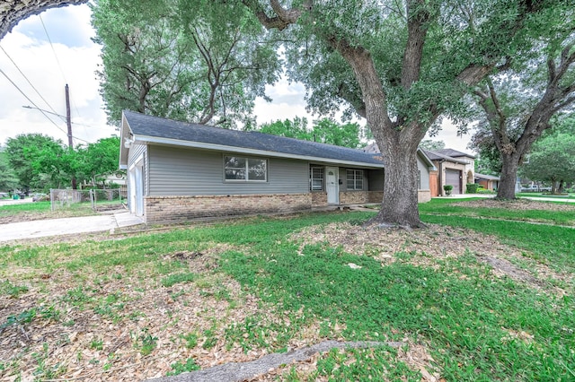 single story home featuring concrete driveway, brick siding, and a garage