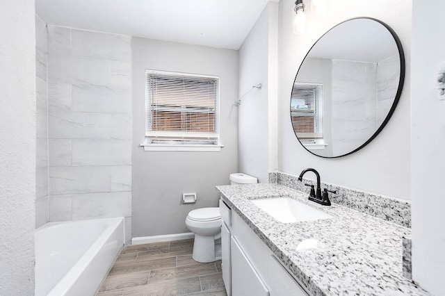 full bathroom with wood tiled floor, plenty of natural light, toilet, and vanity